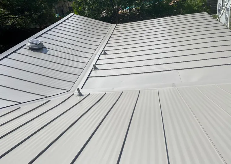 Solar attic fan installed on a metal roof for Roof Ventilation in Beachwood